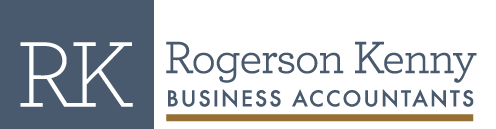 Logo of Rogerson Kenny Business Accountants. To the left, the initials "RK" are displayed in large white letters against a blue square background. To the right, the full name "Rogerson Kenny" is written in blue and "Business Accountants" in black below it, with a brown horizontal line underneath. This Melbourne Accounting Firm symbolizes professionalism and trustworthiness.